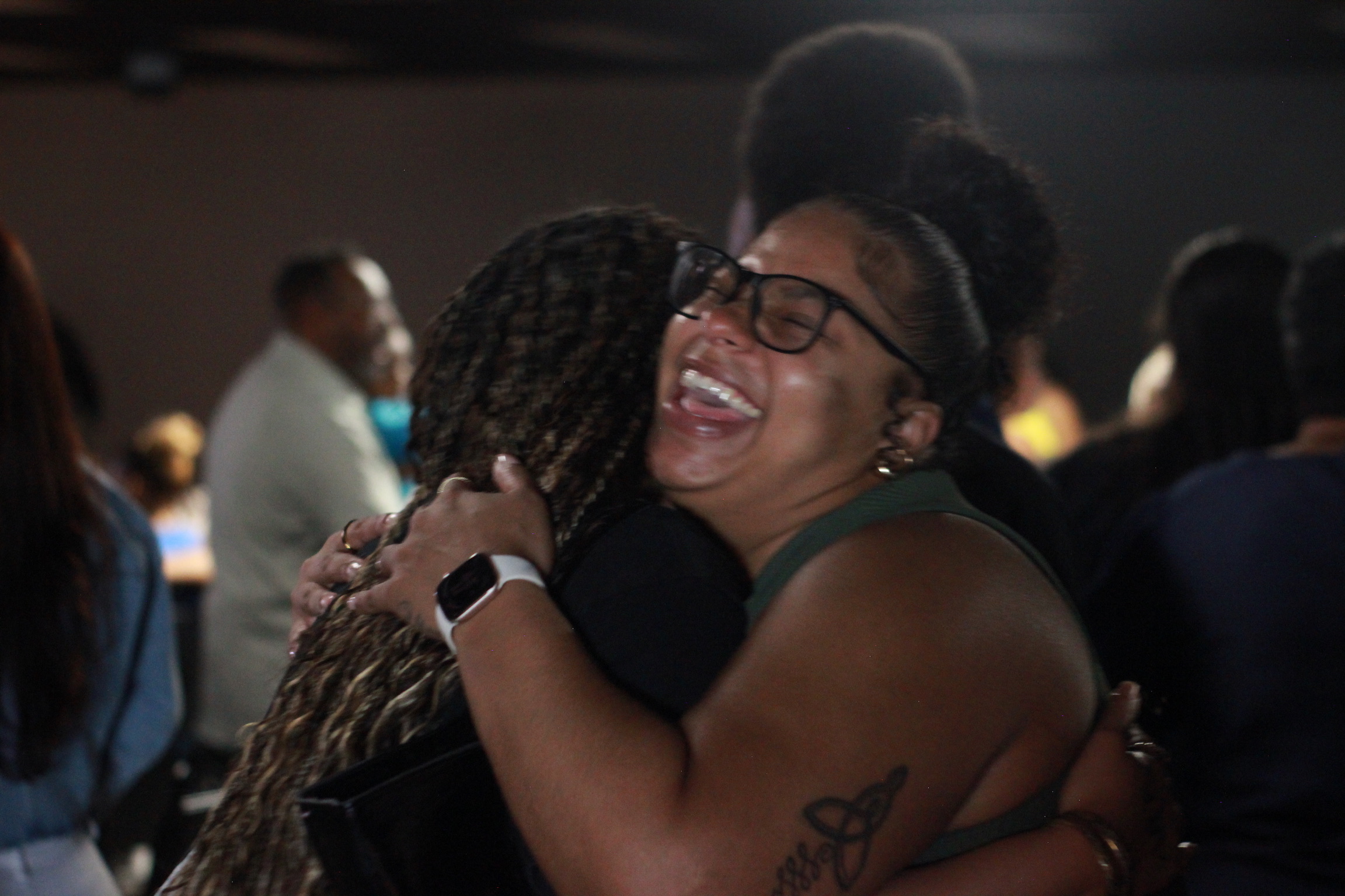 A joyful embrace between two people in the Scarlet Note church family